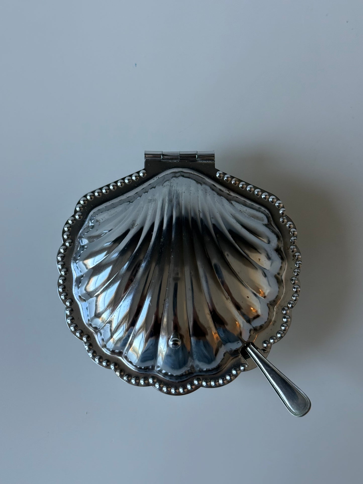 vintage shell-shaped dish with a spoon