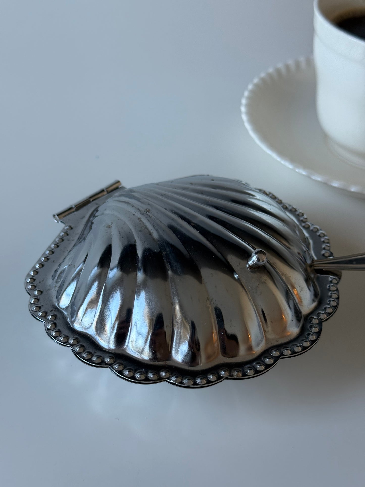 vintage  shell-shaped dish with a spoon