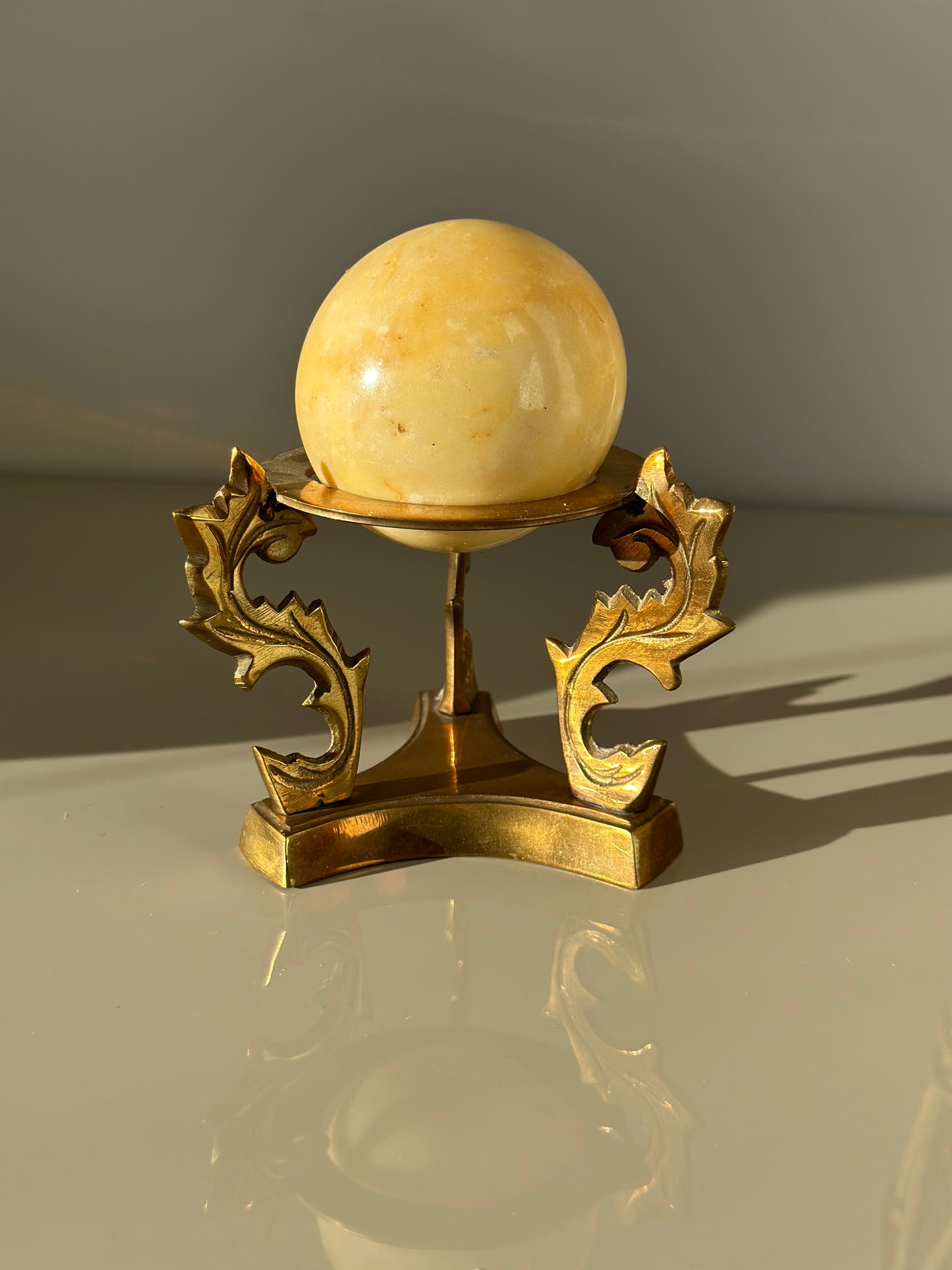 Marble sphere and brass stand