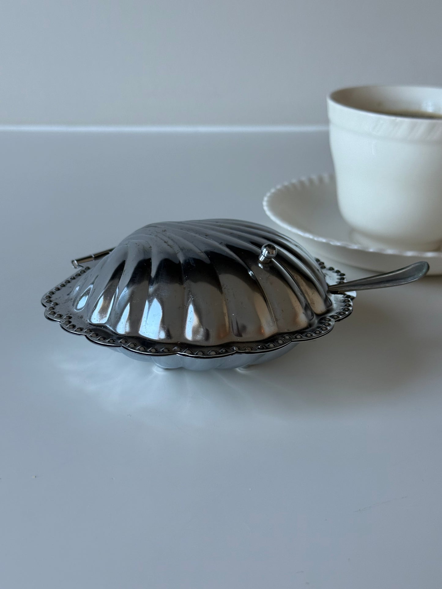 vintage  shell-shaped dish with a spoon