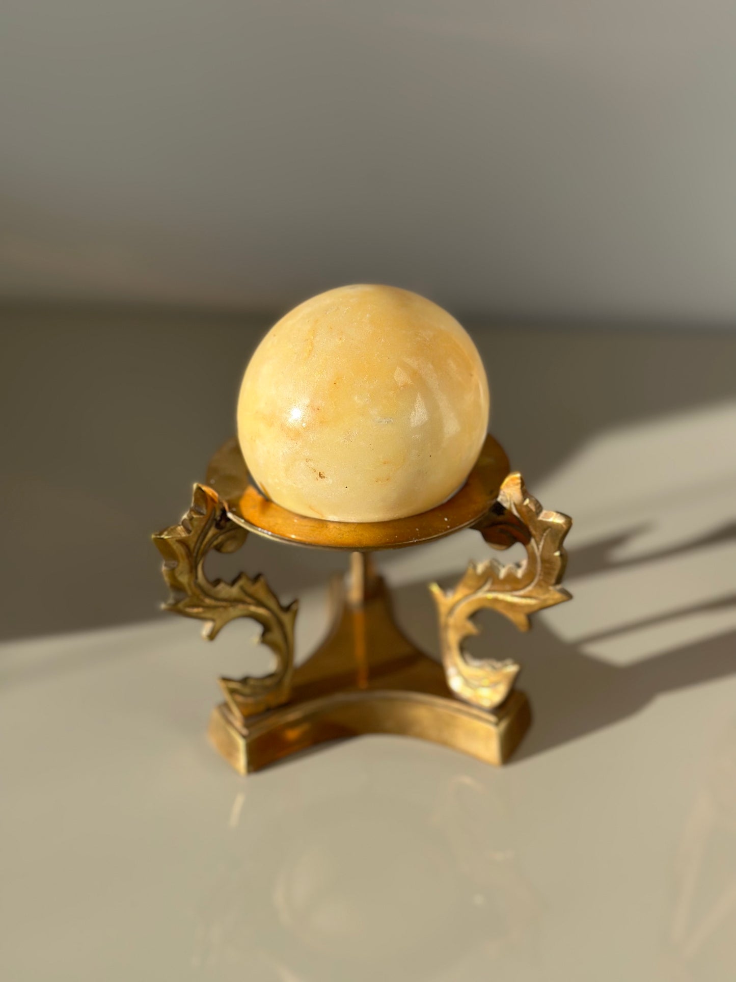 Marble sphere and brass stand