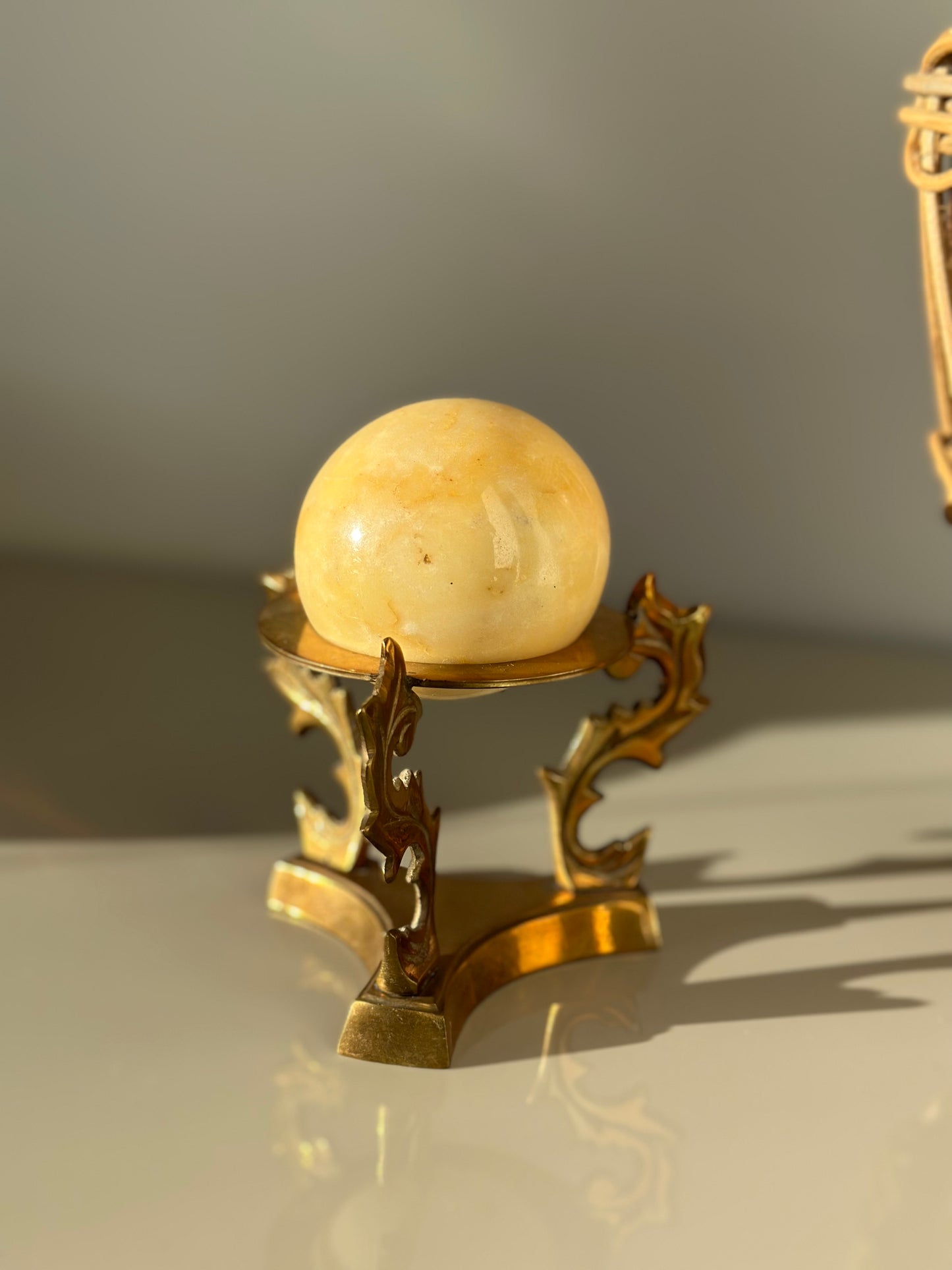 Marble sphere and brass stand