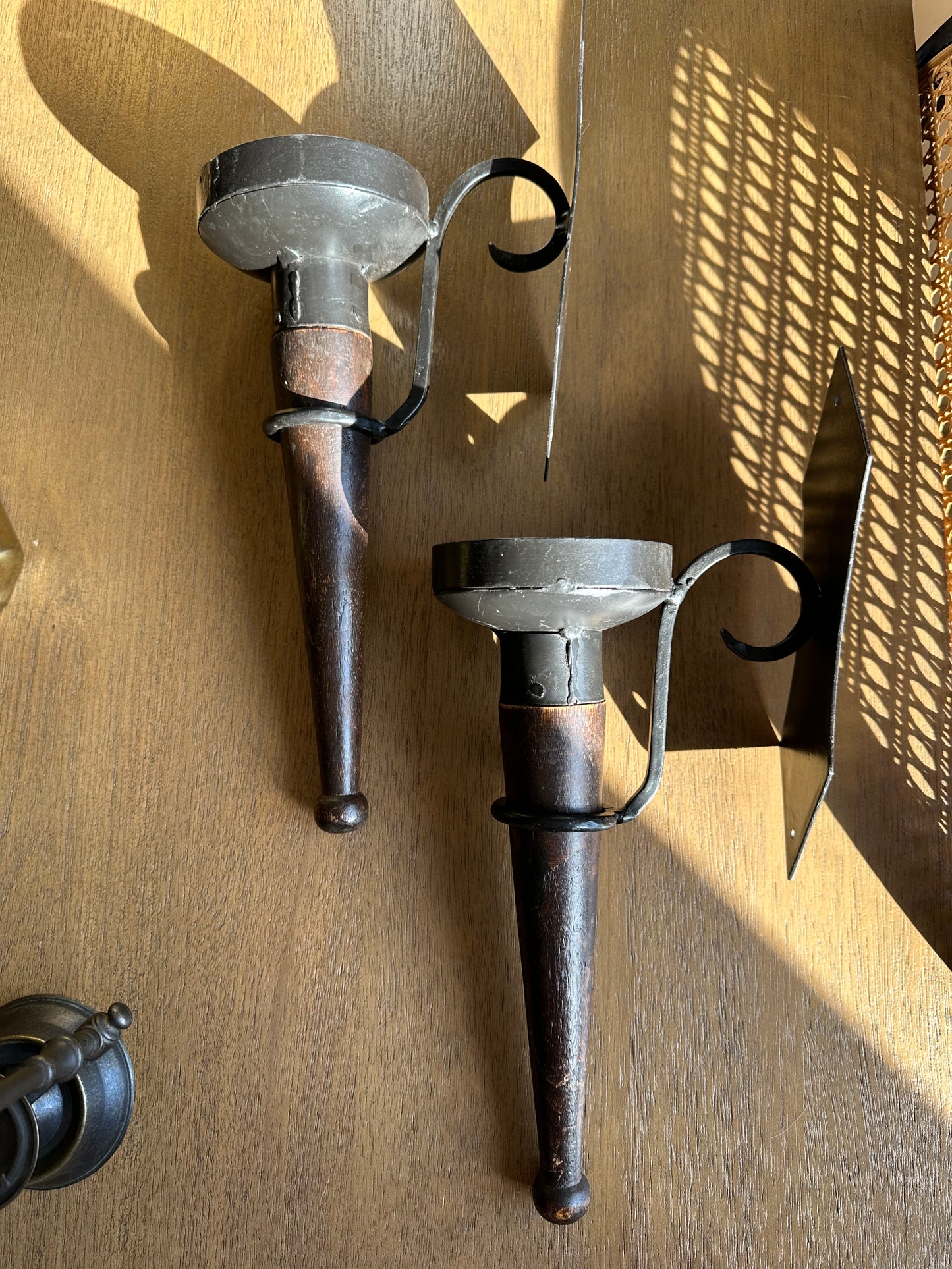 Two iron hanging candleholders