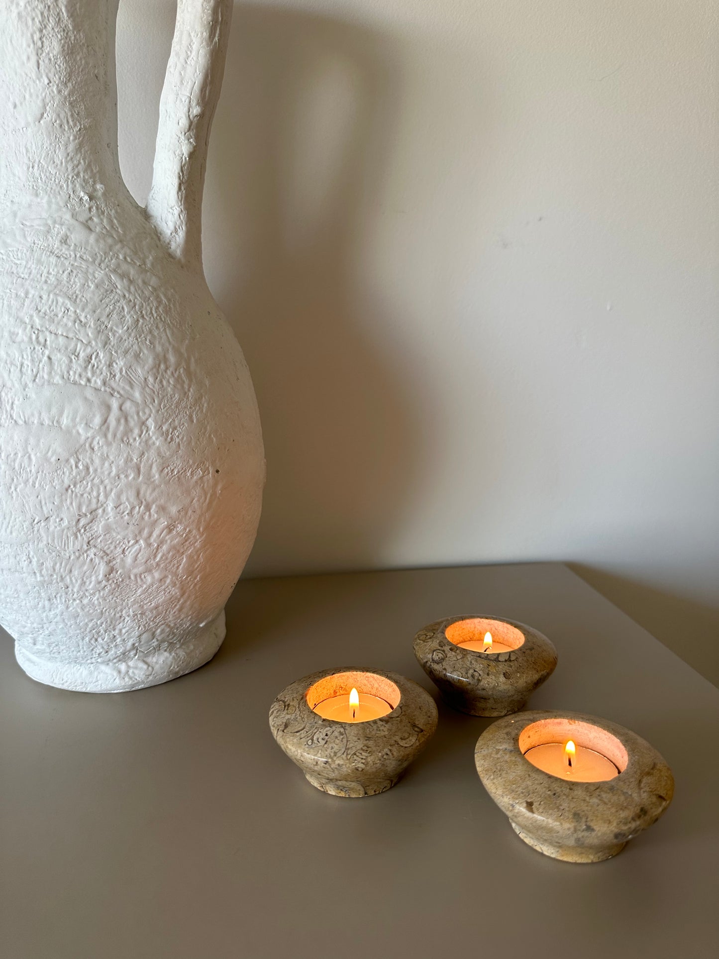 Three fossil tealight holders