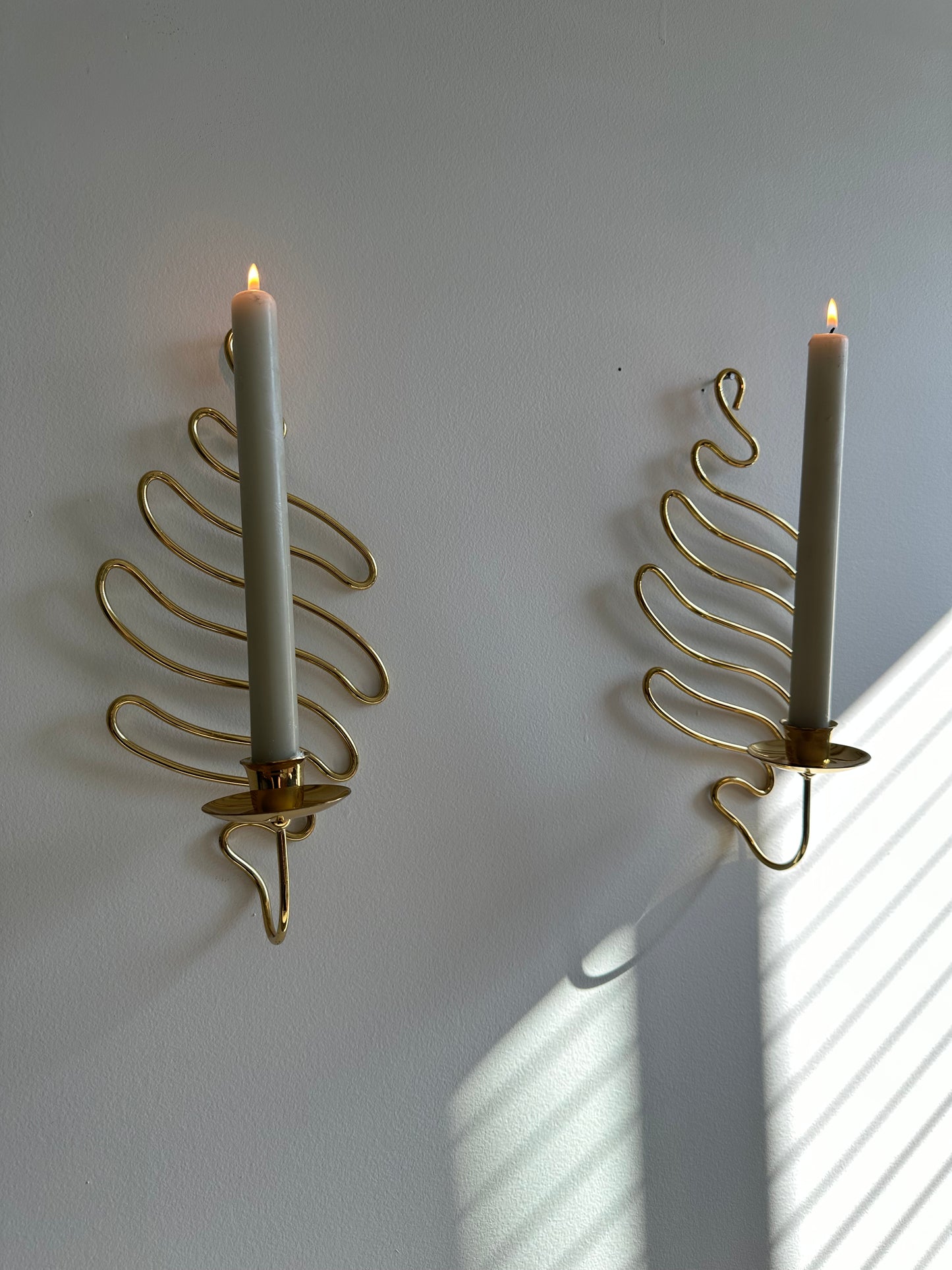 Brass swirl sconces