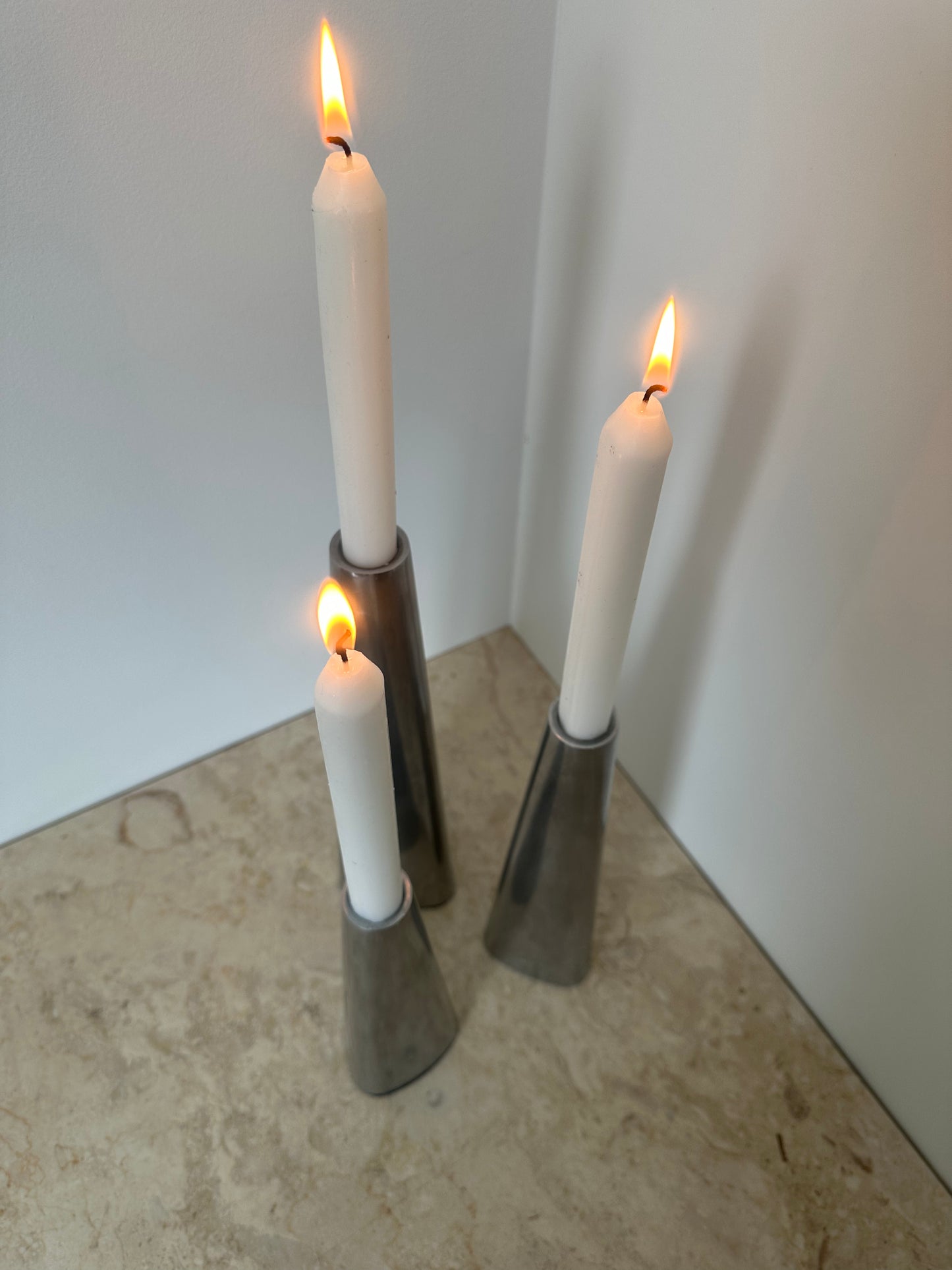 Three silver candleholders