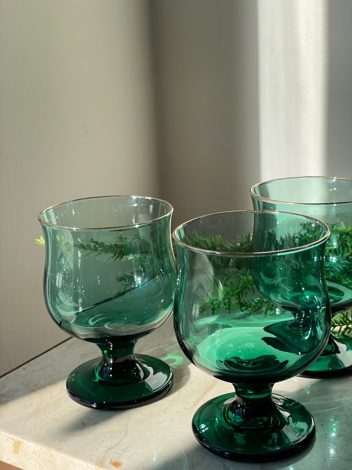 Four green glasses with gold rim