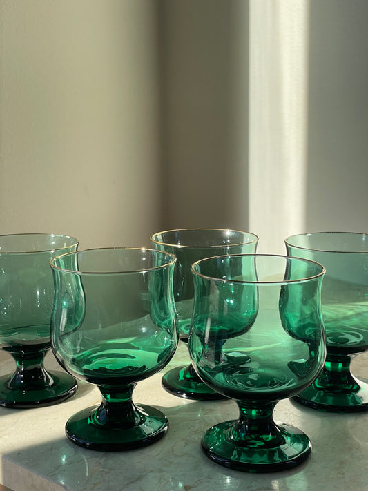 Four green glasses with gold rim