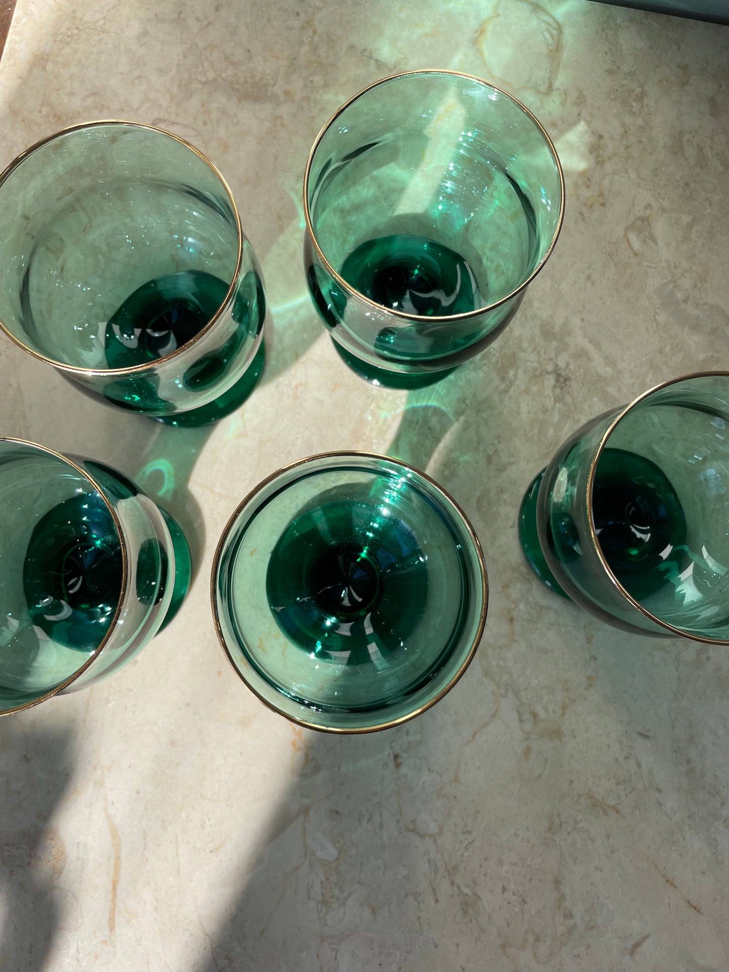 Four green glasses with gold rim