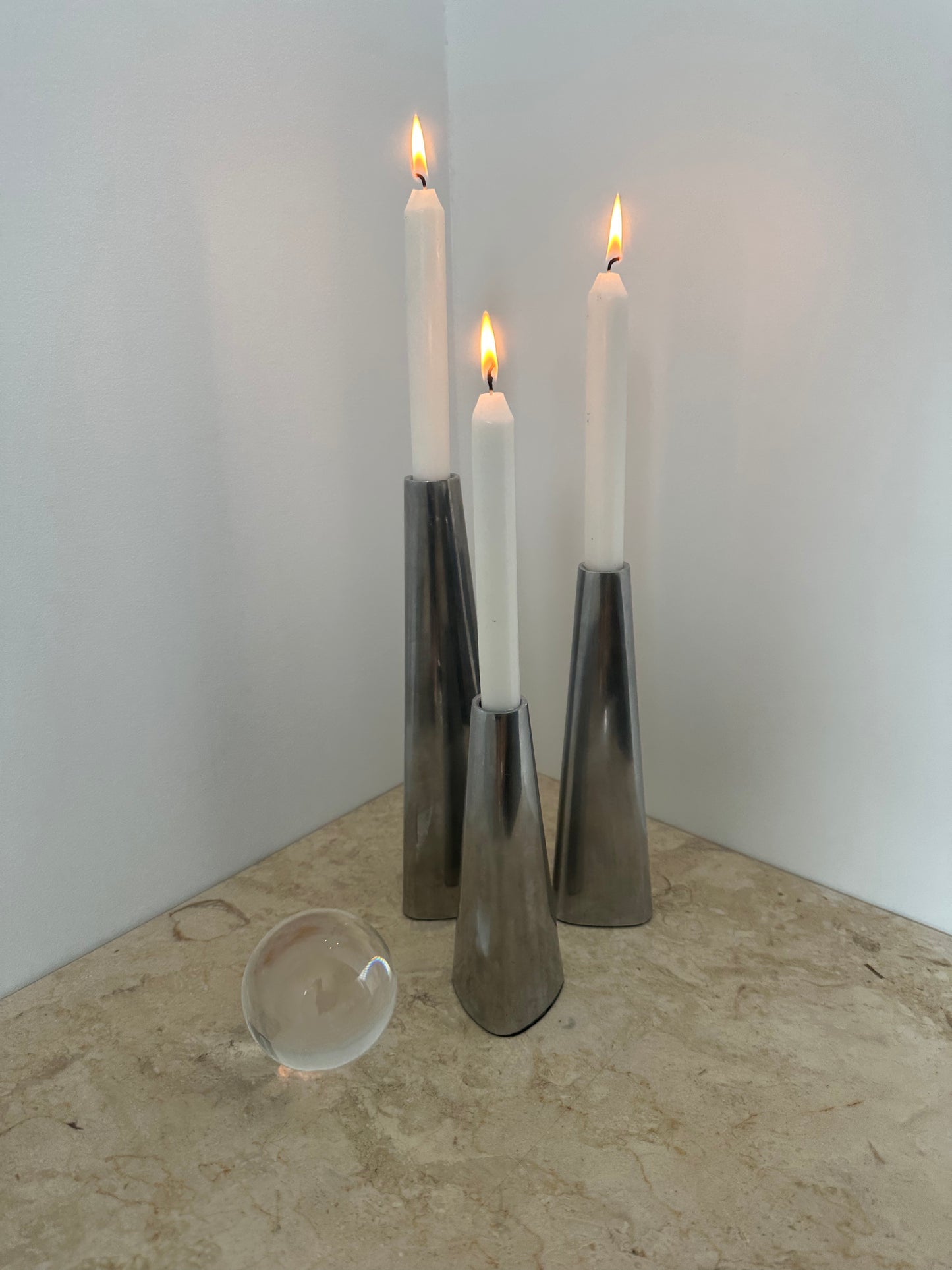 Three silver candleholders