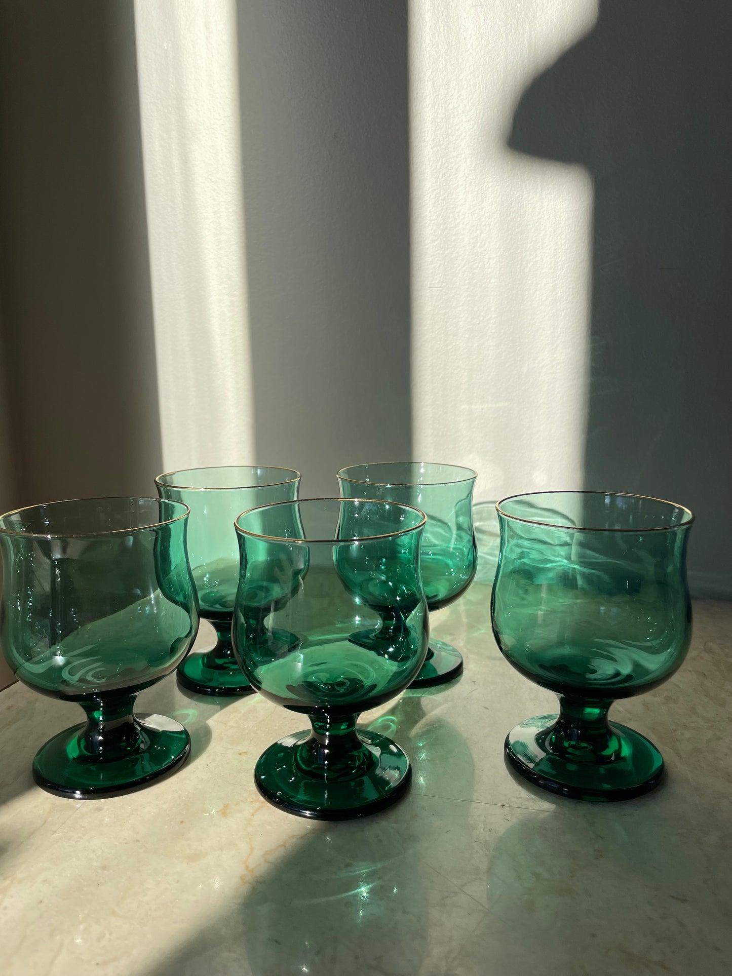 Four green glasses with gold rim