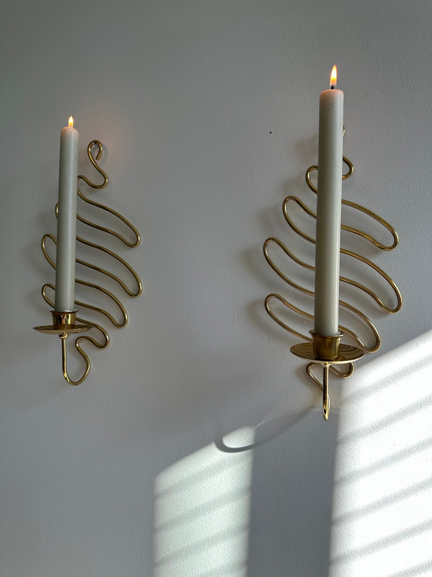 Brass swirl sconces