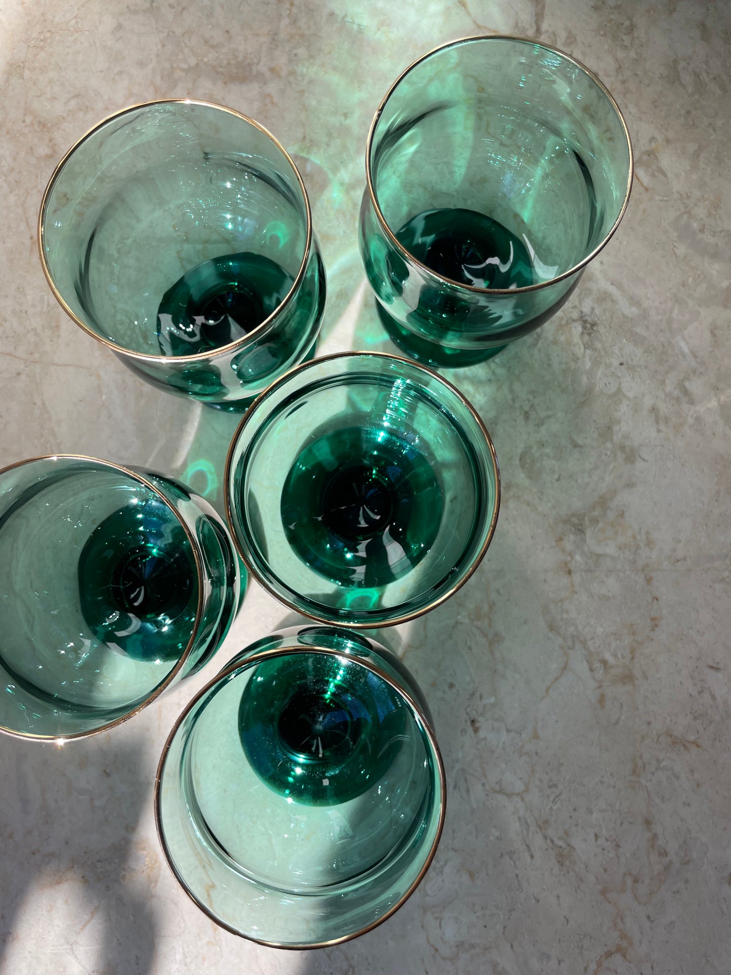 Four green glasses with gold rim