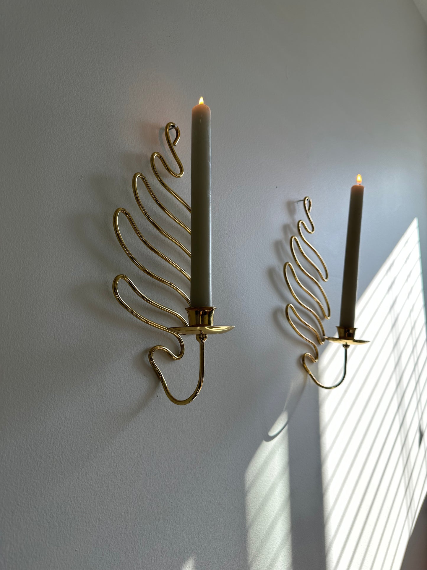 Brass swirl sconces