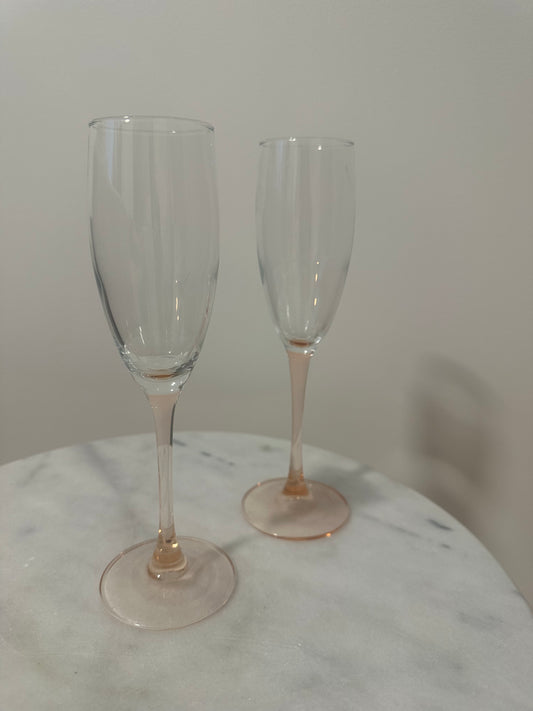 Two pink stem champagne glasses