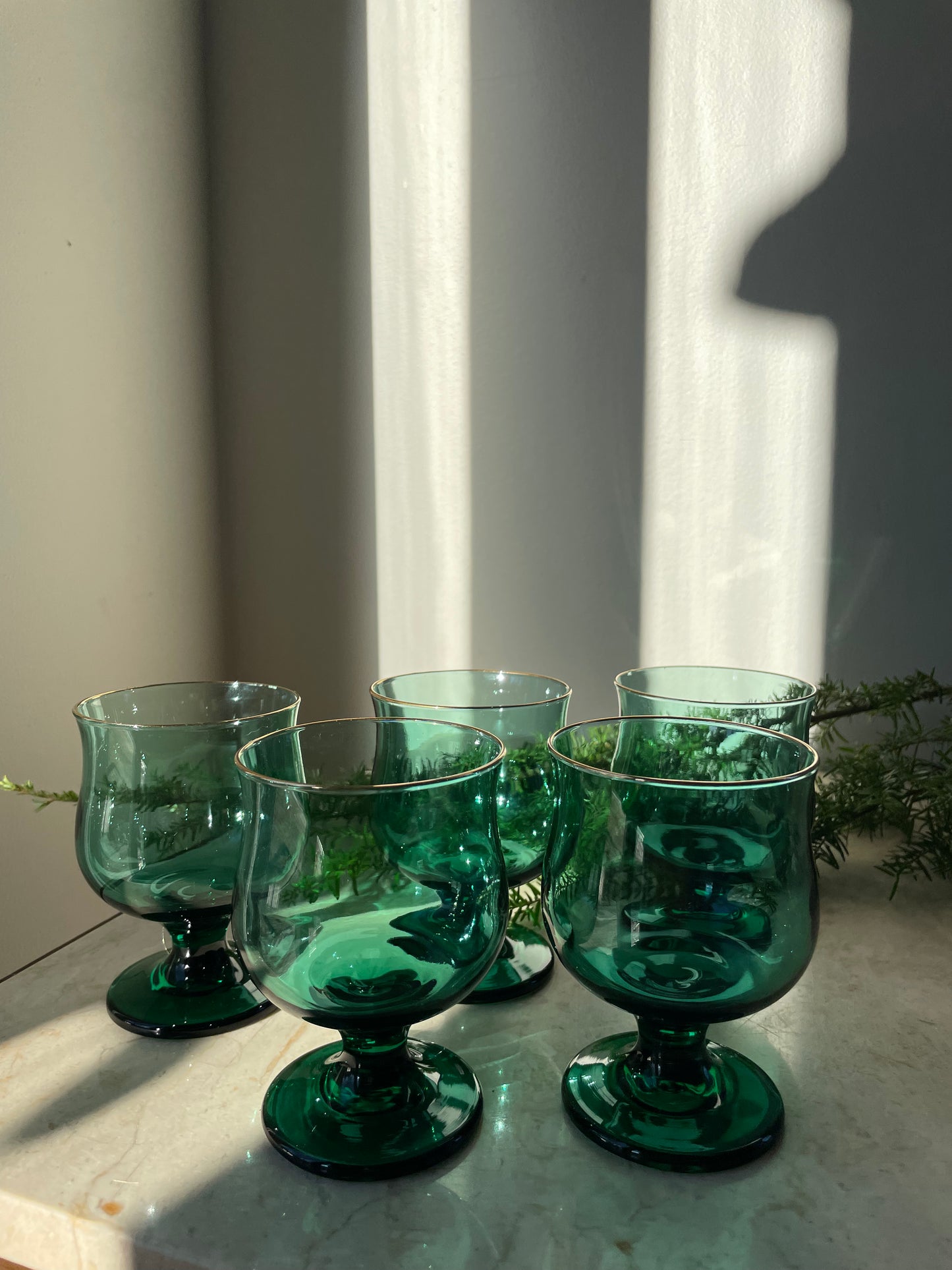 Four green glasses with gold rim