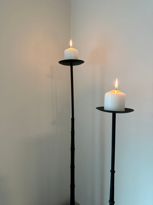 Two tall iron candleholders